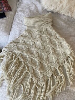 Fringe Cable-Knit Turtleneck Poncho in Cream